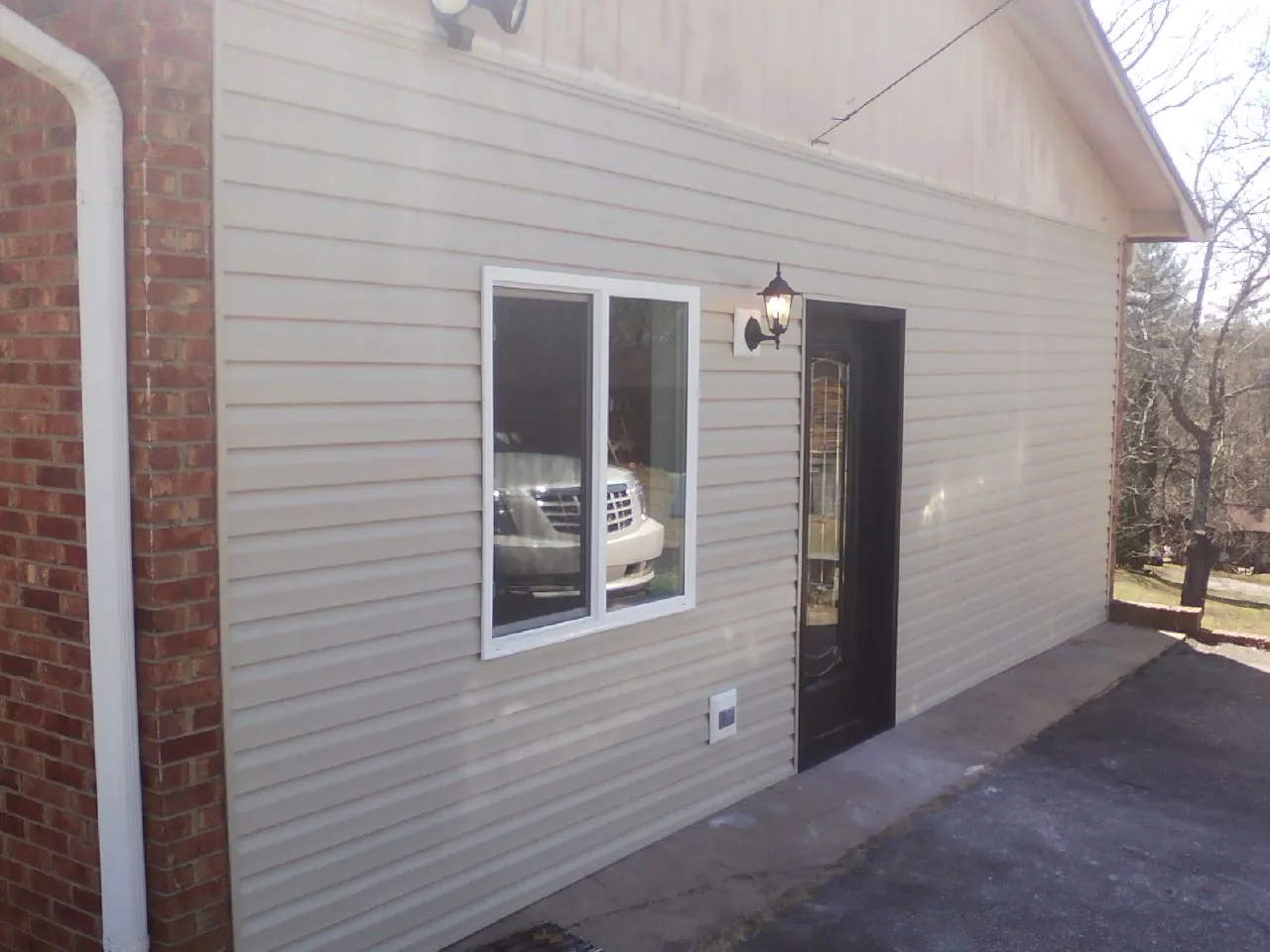 New vinyl siding and entry door on a room addition in Kenmare